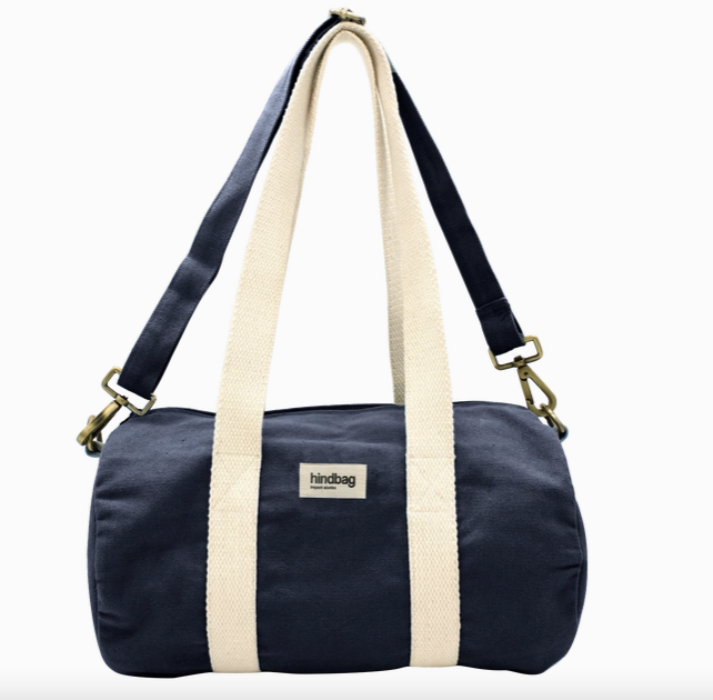 Navy blue duffel bag with beige straps on a white background