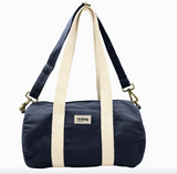 Navy blue duffel bag with beige straps on a white background