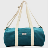 Teal duffel bag with white straps on a light gray background