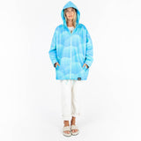 Person wearing a blue tie-dye hoodie on a white background